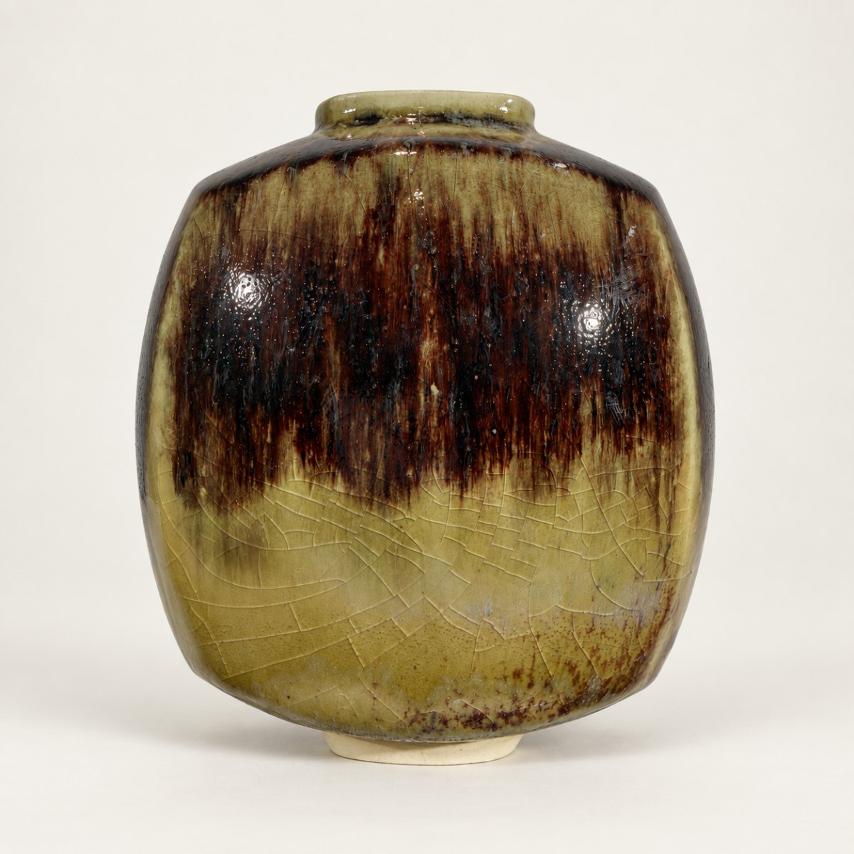 Slipcast form, olive ash glaze with dark tenmoku break at the shoulder