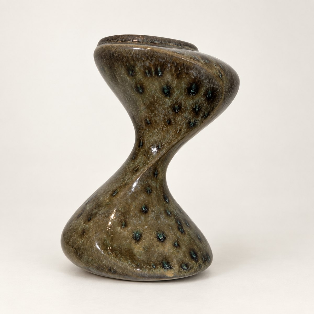 Twisted hourglass vase, mottled olive glaze with dark blue-green spots